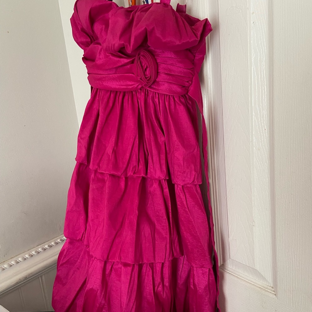 This is a custom made dress. It’s pink and beautiful. Only worn 3 times
